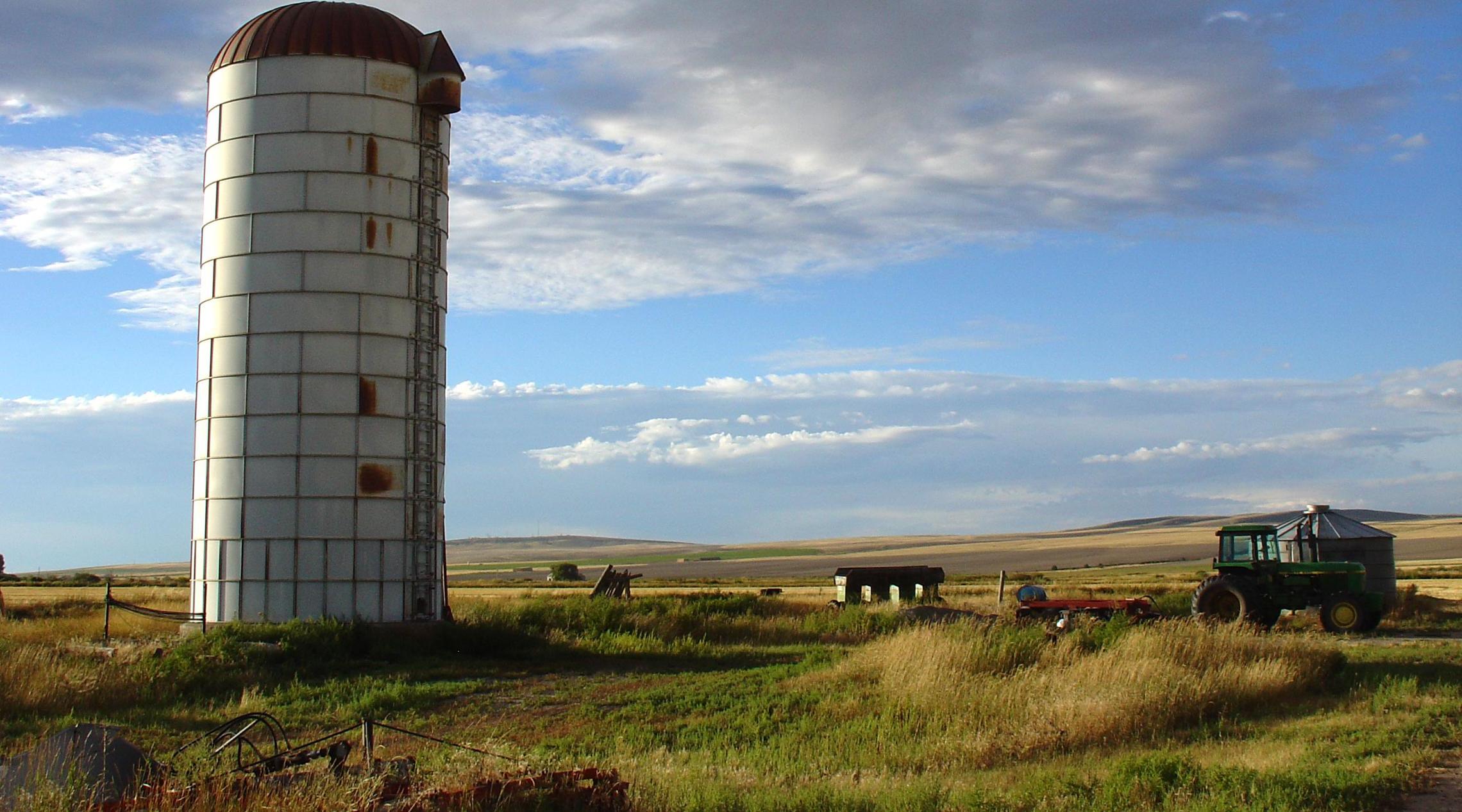 Old silo and farm with a blue sky